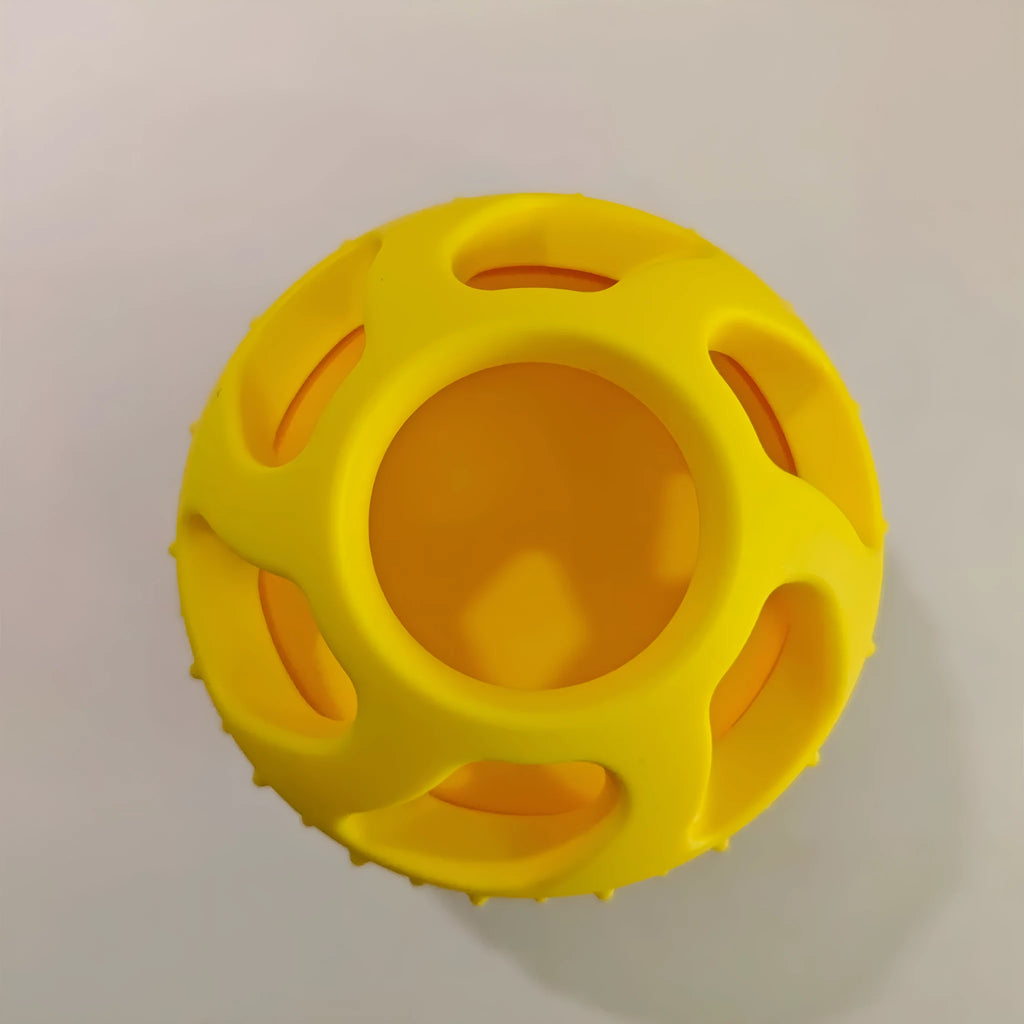 Yellow silicone dog toy ball with snack mould for slow feeding and dental care