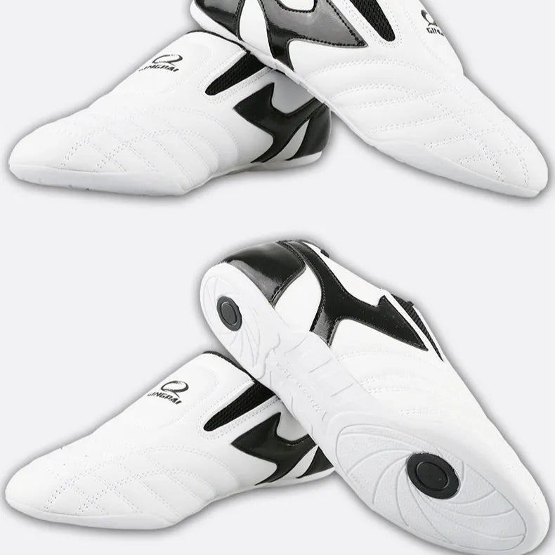 Black and white children's Sanda martial arts training shoes with a soft sole, shown with a shoe bag and socks.