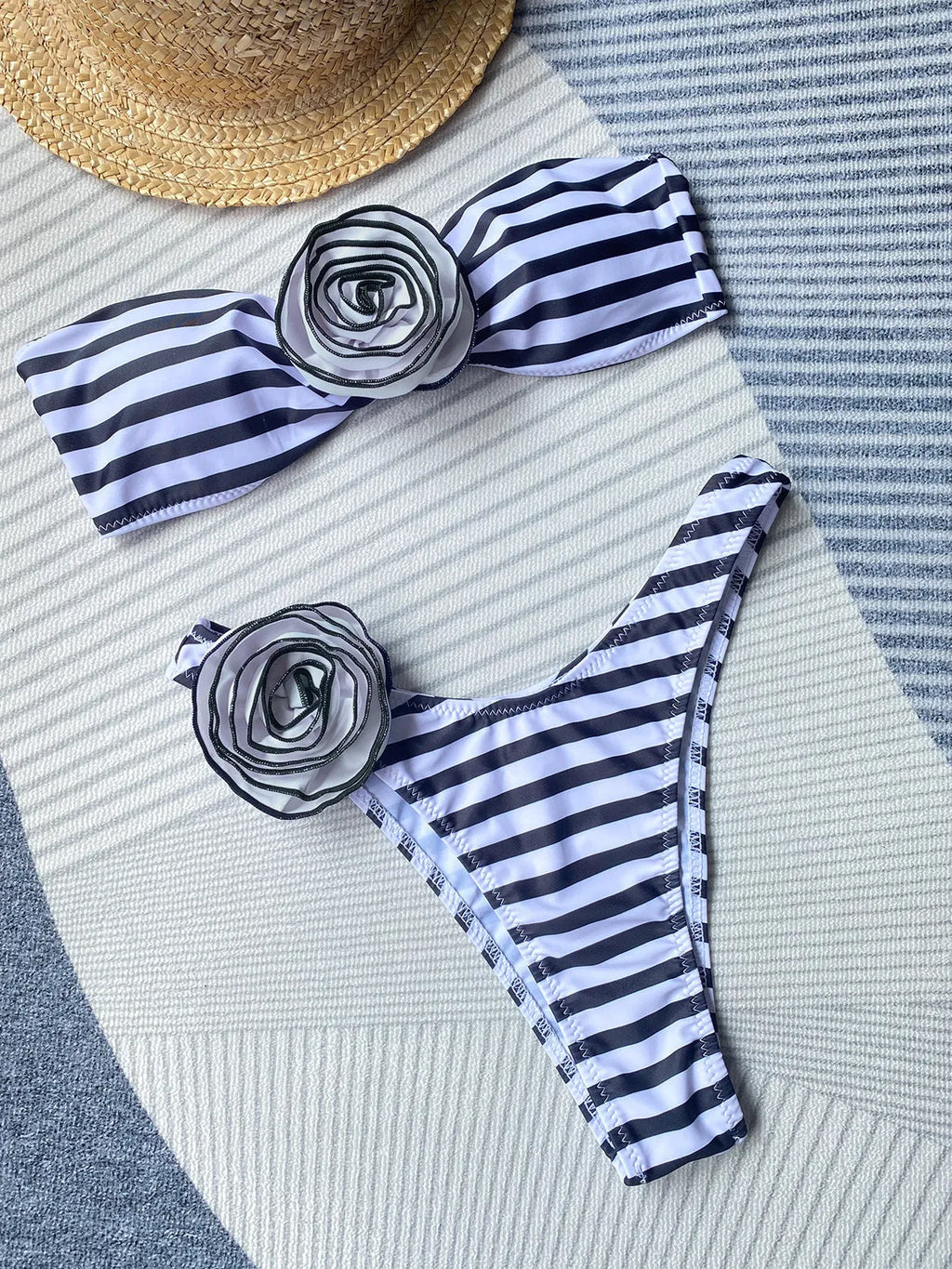 Black and white striped bikini with cross-back tube top and floral split detail on the shorts.