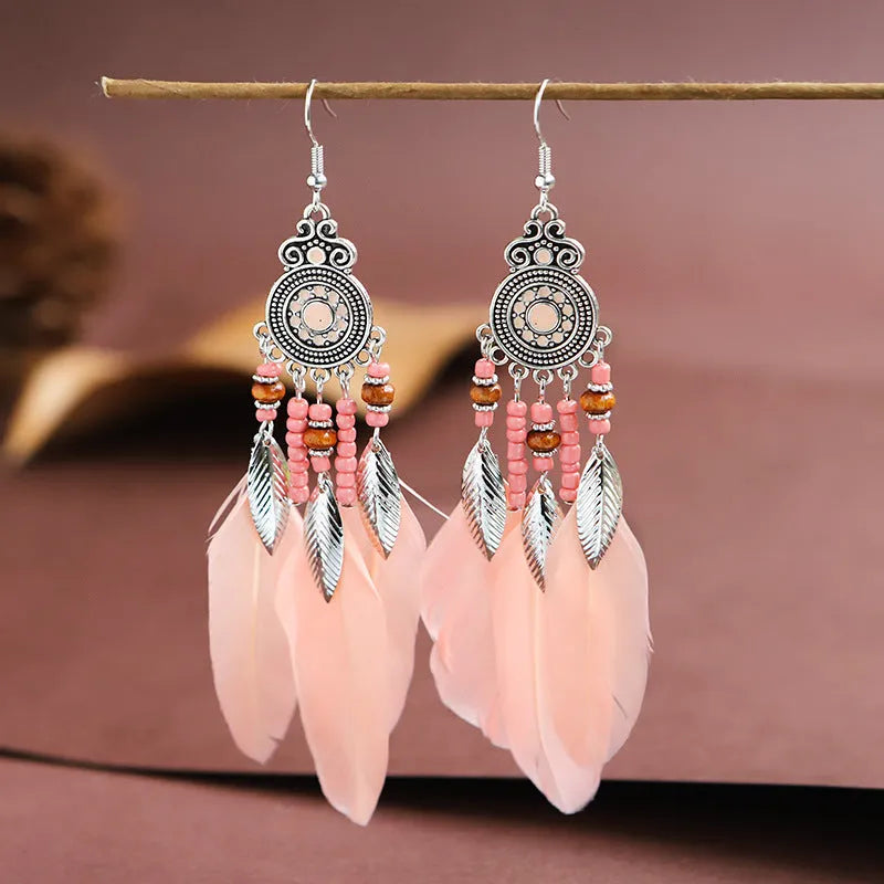 Round drop feather earrings with leaf patterning in alloy, available in multiple electroplated colours.
