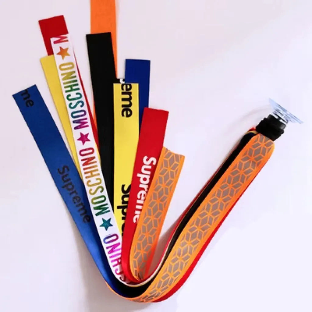 Colourful fabric helmet streamers for children's roller skating and ski helmets, shown in apricot, red, and grey.