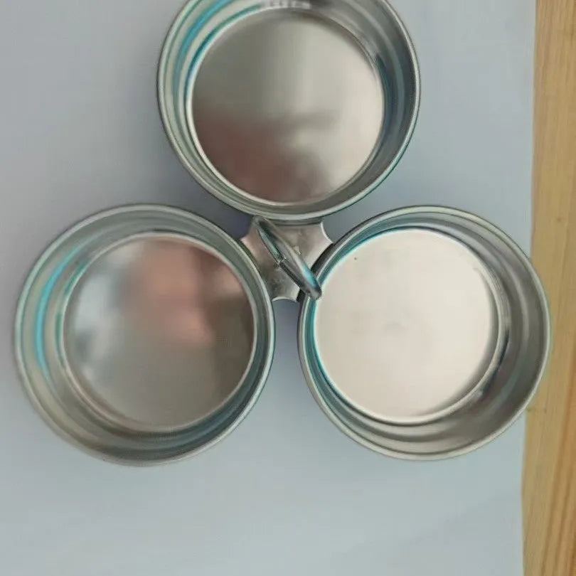 Mini stainless steel egg steamer showing both round and heart-shaped design options on a kitchen counter.