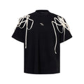 Black loose fit T-shirt with padded shoulders featuring rivet ribbon decoration and short sleeves