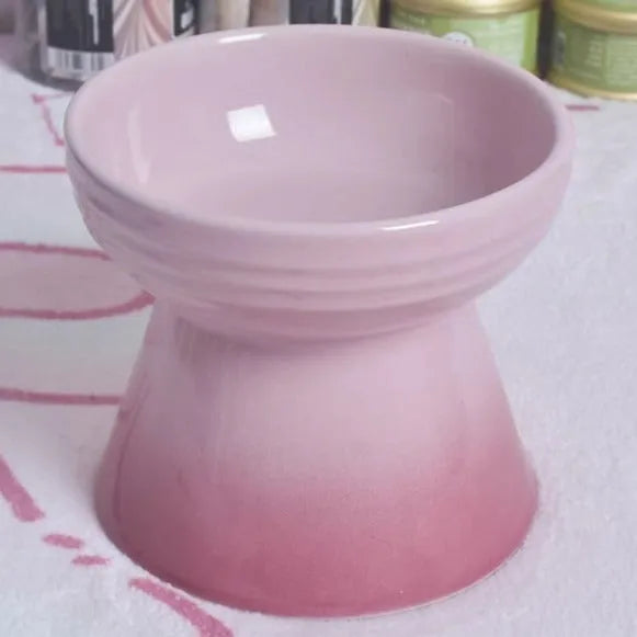 Black chin-high foot ceramic pet bowl for dogs and cats on a flat surface.