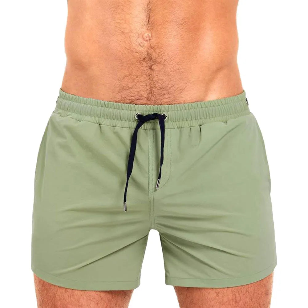 Solid colour polyester swimming and sports shorts with mesh lining in army green, on a white background.