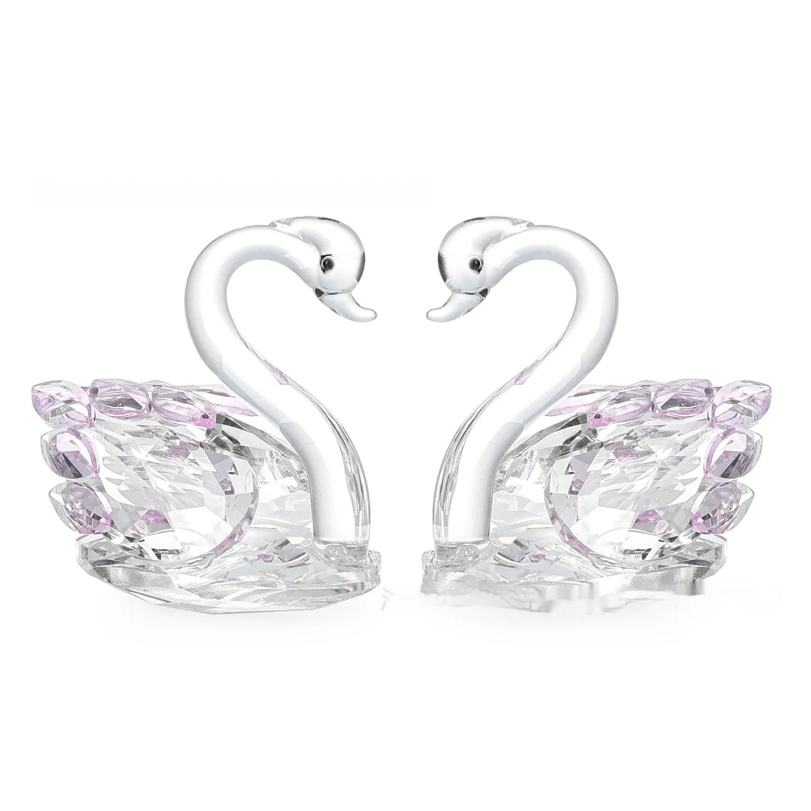 White crystal swan decoration on a desktop in solid head and empty tube styles.