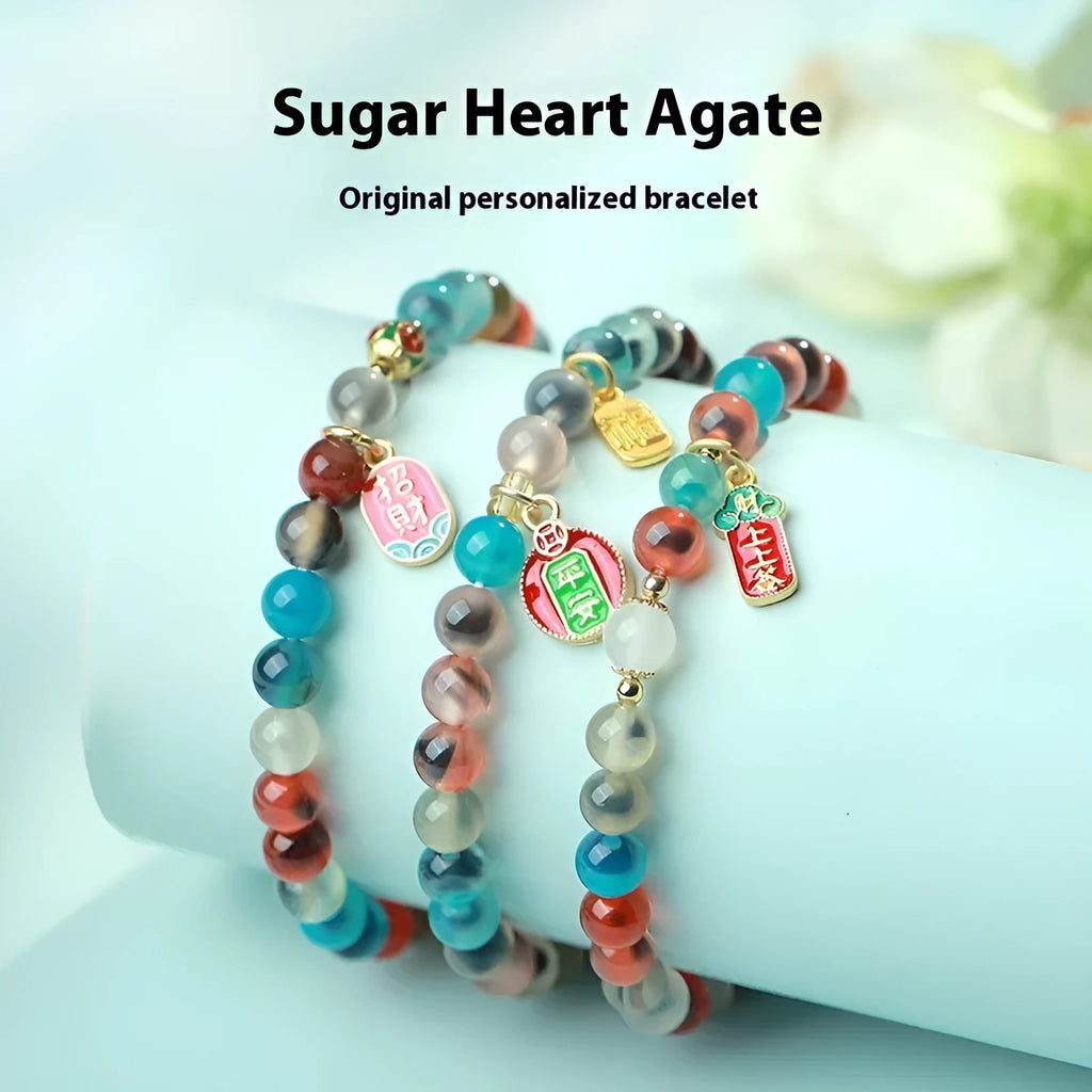 Handmade women's agate bracelet with coloured glaze copper coins in a snake chain, showing fu character or swallowing gold beast motifs.