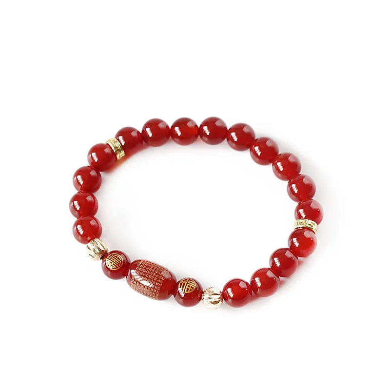 Agate Guanyin prayer bead bracelet in green or red on a wrist, showing auspicious patterns and charm.
