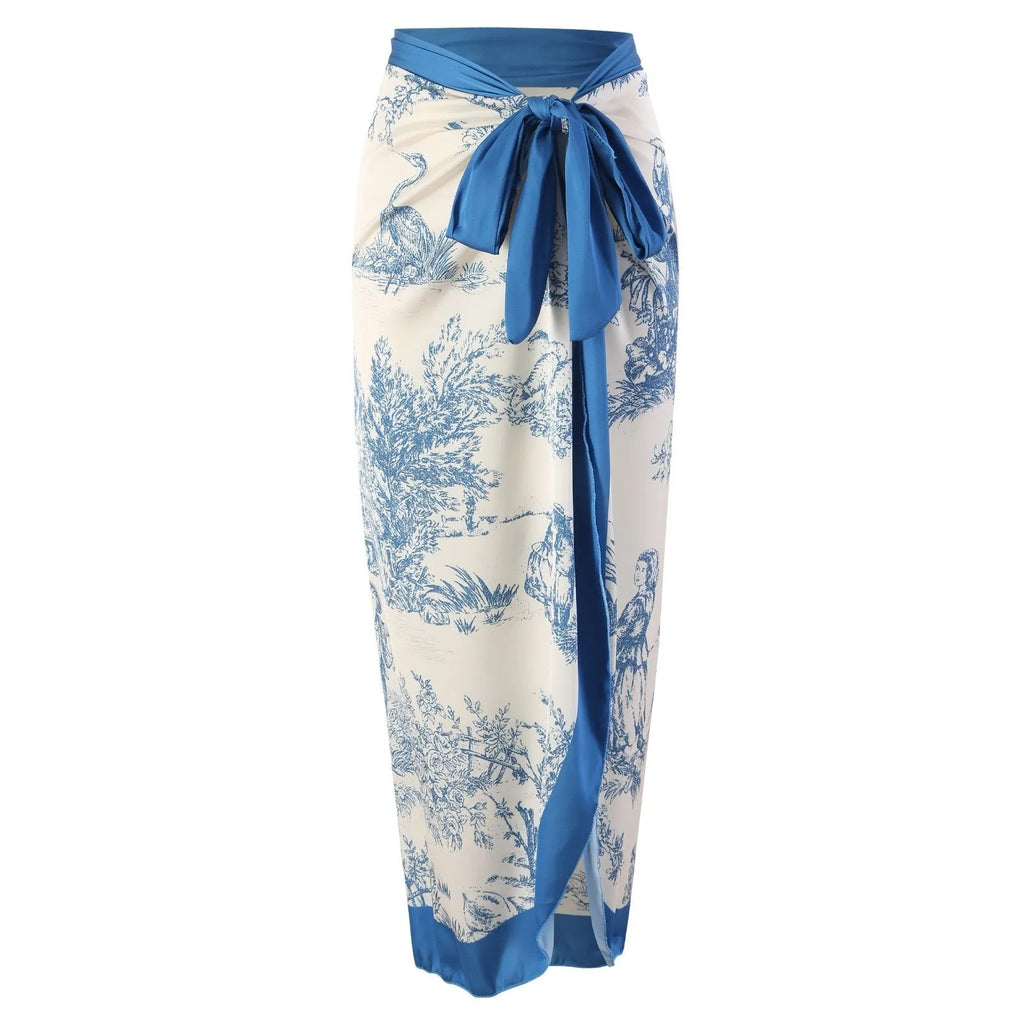 Blue patterned women's one-piece swimsuit shown with a matching light gauze skirt.