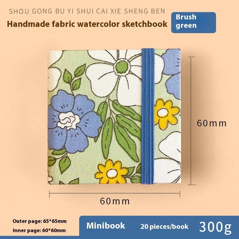 Feiluniao handmade fabric watercolour notebook in 185mm portable size, showing artistic cover design.