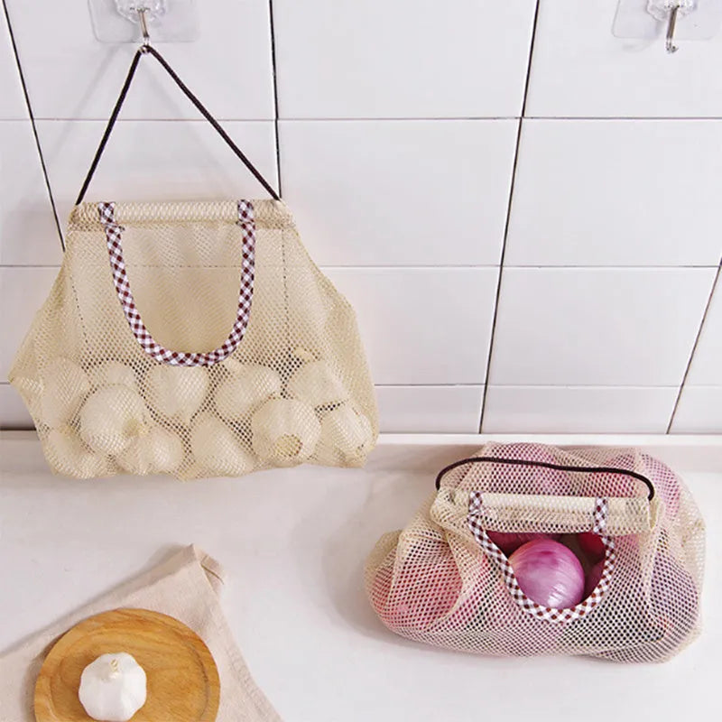 Beige plaid polyester mesh kitchen storage bag with cotton rope loops on a wall hook, 26x29cm