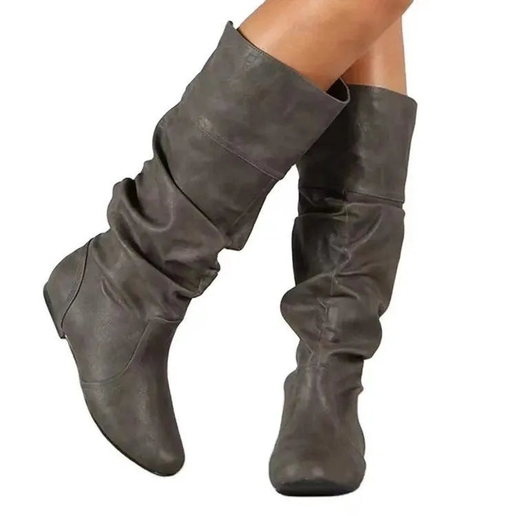 Women's slip-on knee high flat boots in artificial PU upper with round toe and rubber sole