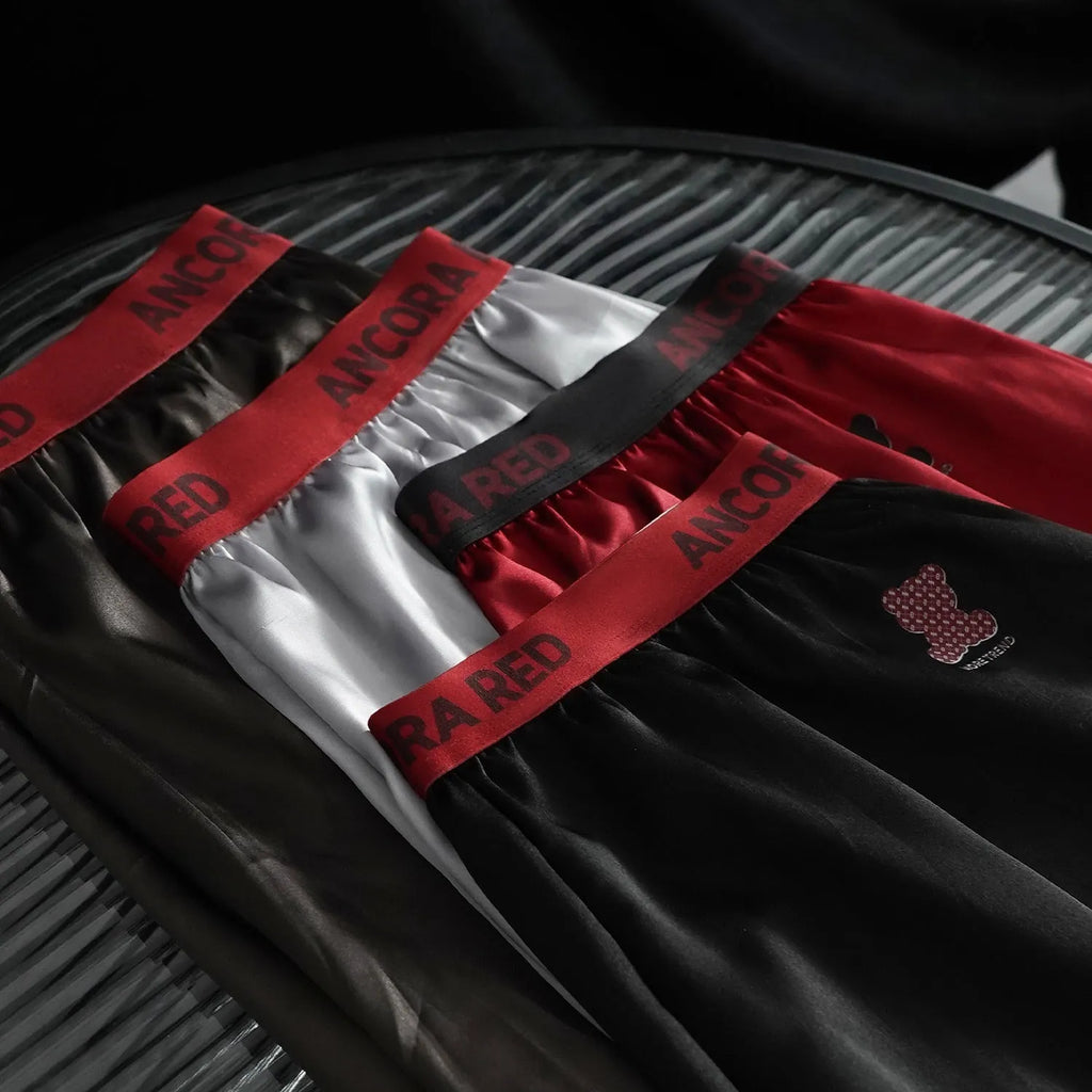 Men's solid colour boxer briefs in black, blue, brown, purple, red, and silver with elastic mid waist