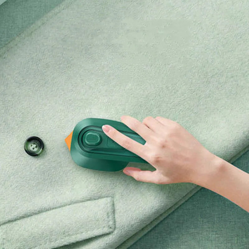 Dark green portable handheld hanging steam ironing machine with ceramic panel and power cord.