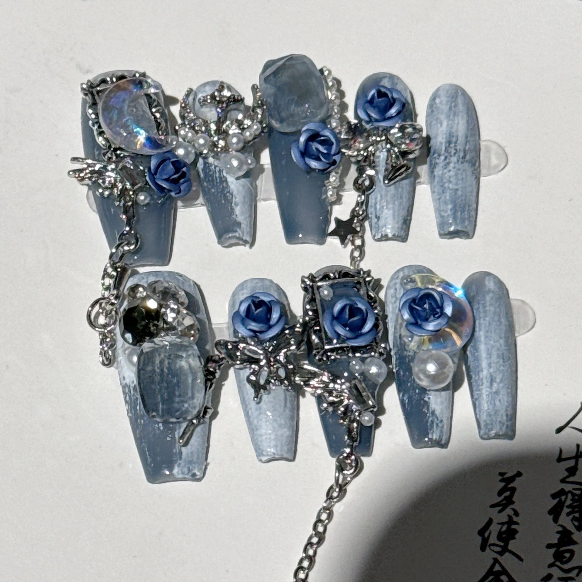 Heavy industry blue false nails with ornate rose and tulip pattern, shown in sizes XS S M L.