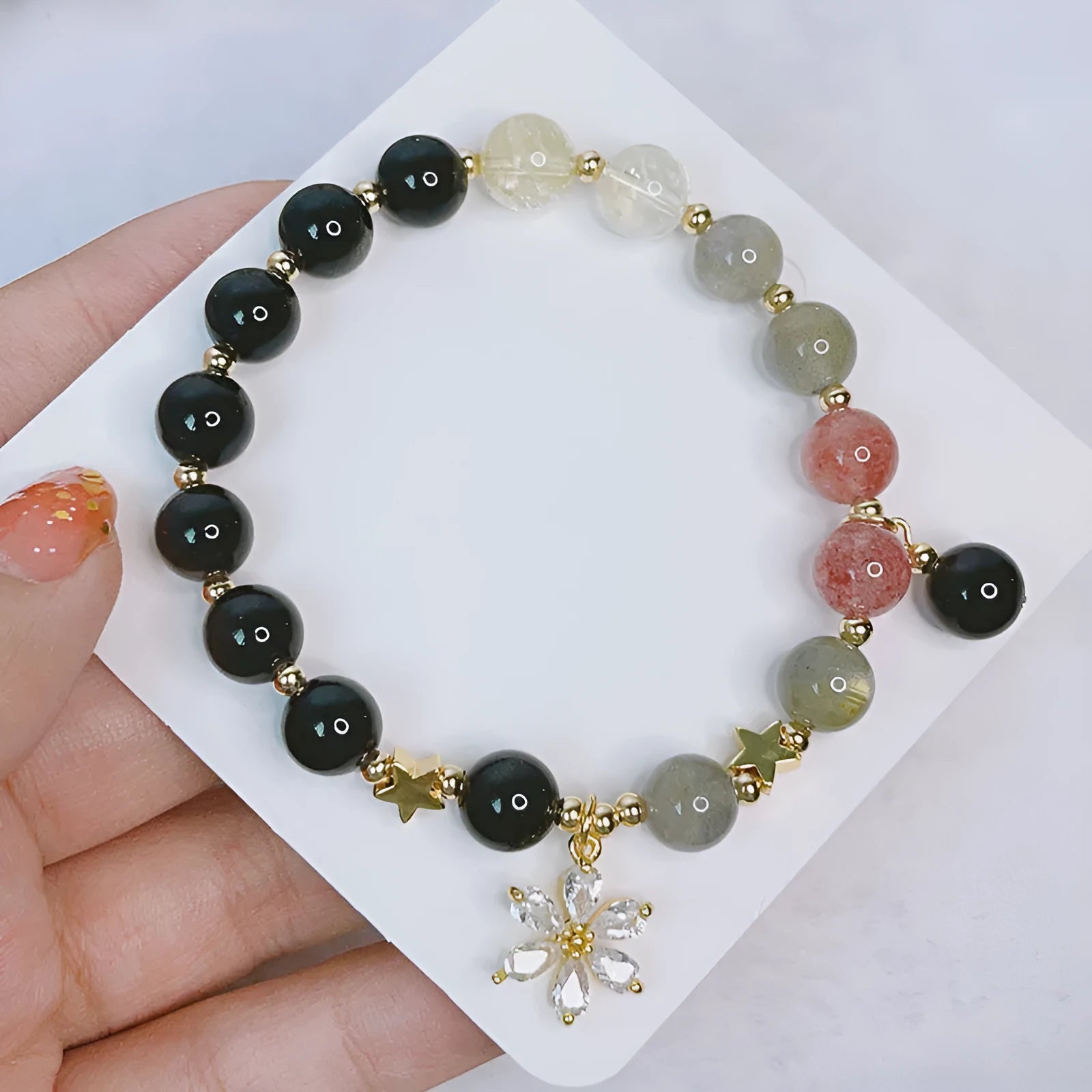 Silver stone bracelet for women with electroplated finish showing flower, love heart and star charm options