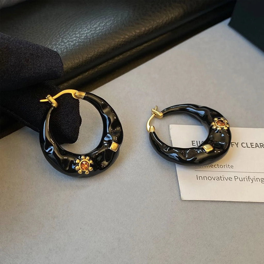Black and red alloy ear studs with rhinestone inlays and dripping oil textured surface