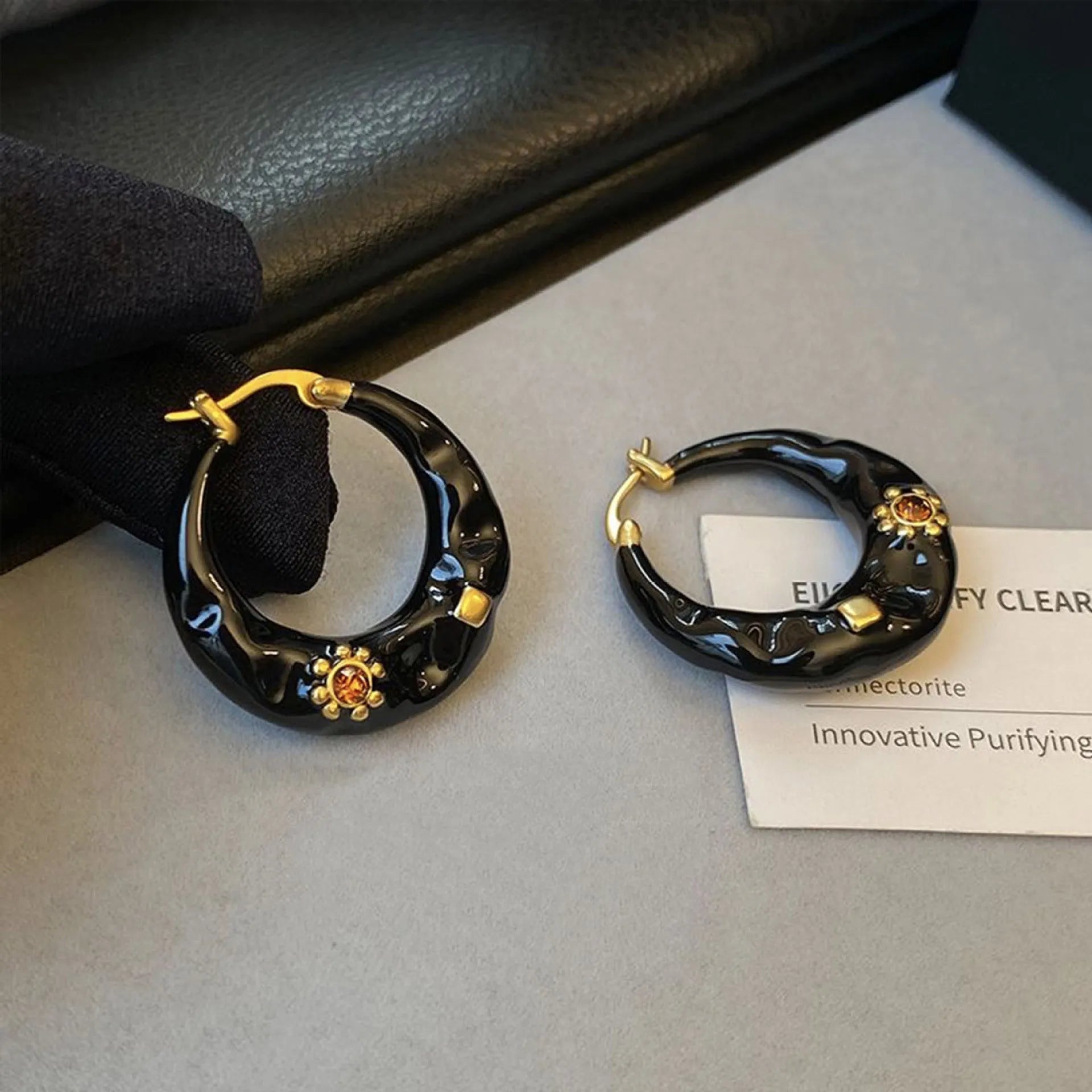 Black and red alloy ear studs with rhinestone inlays and dripping oil textured surface