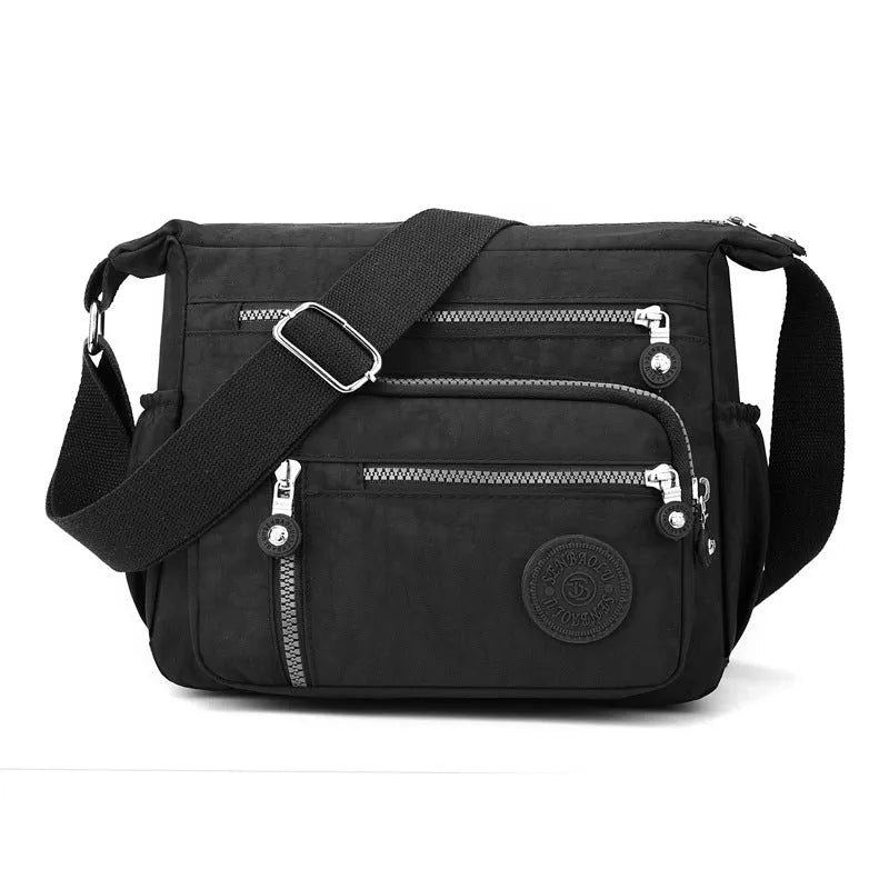 Grey lightweight nylon messenger bag with large capacity and single shoulder strap.