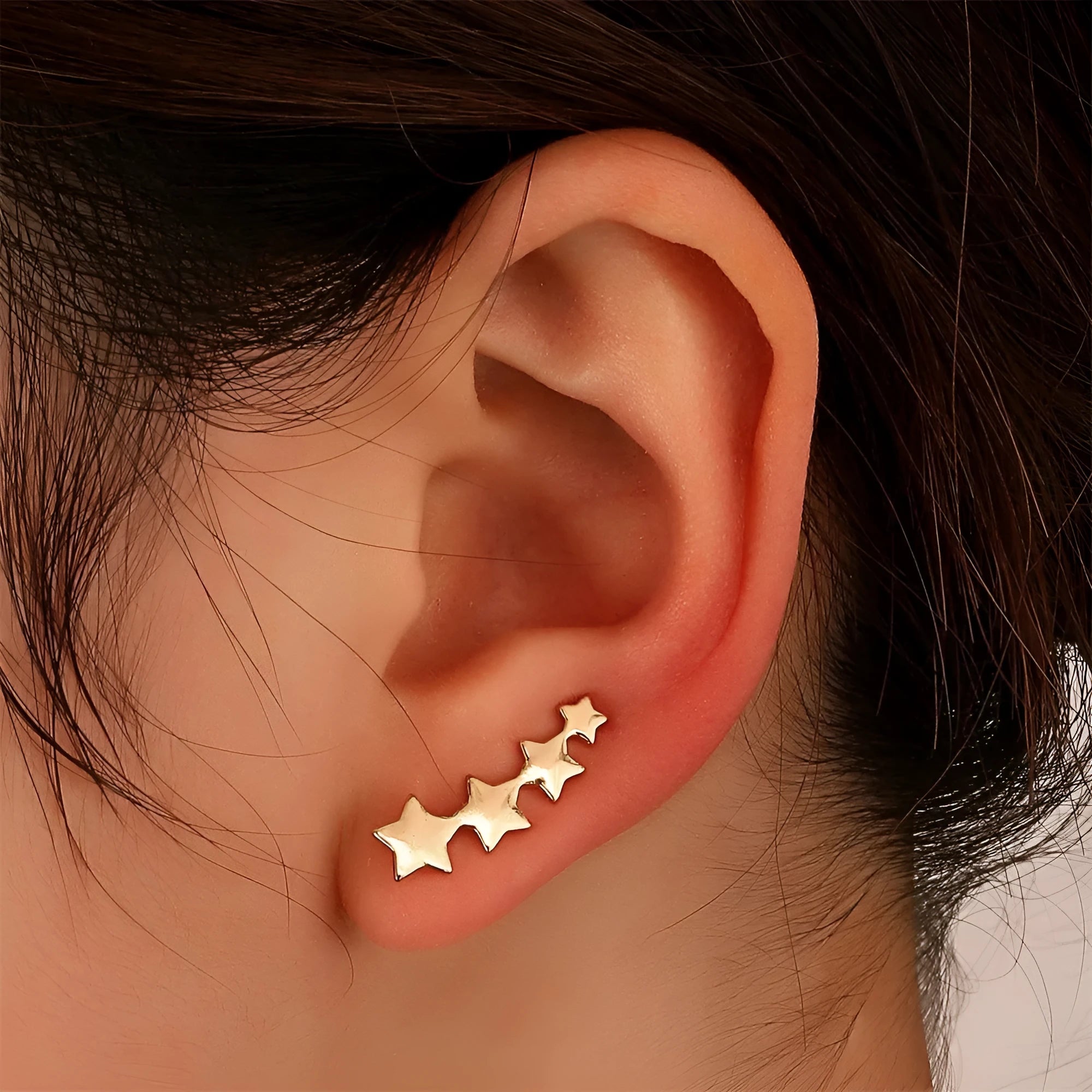 A pair of copper-coloured leaf-shaped clip-on earrings for women.