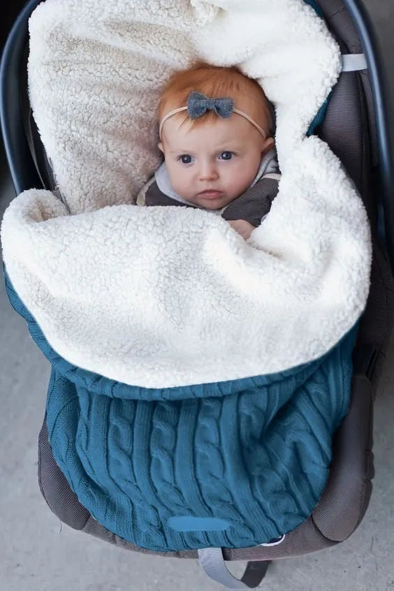 Envelope-style baby stroller sleeping bag in a choice of colours with cotton wool filling.