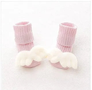 Cotton baby socks in multiple colours and prints including panda, lion, bows, and stars on a white background.