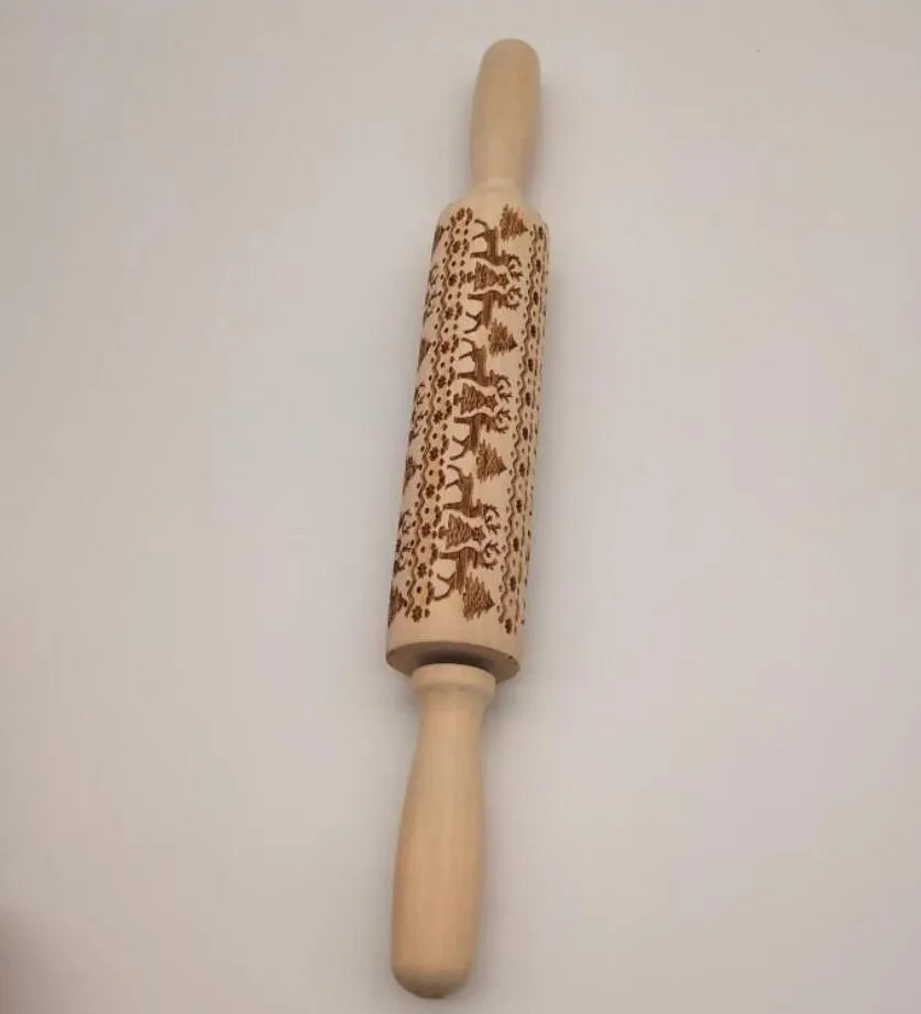 Wooden rolling pin with embossed Christmas pattern, measuring 45cm long.