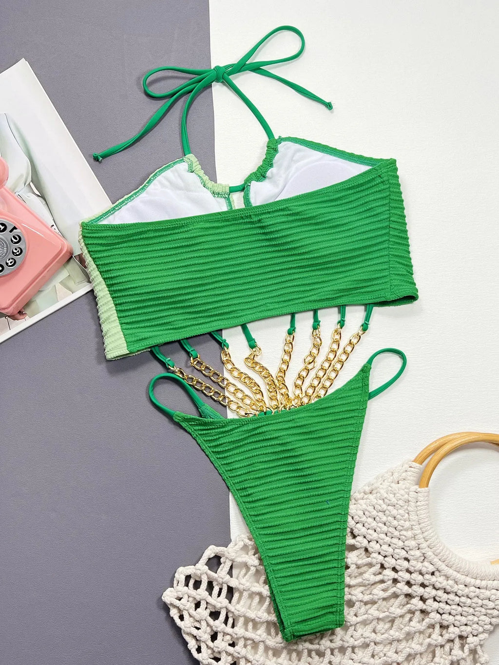 Green women's one-piece swimsuit with a hollow sexy design on a mannequin.