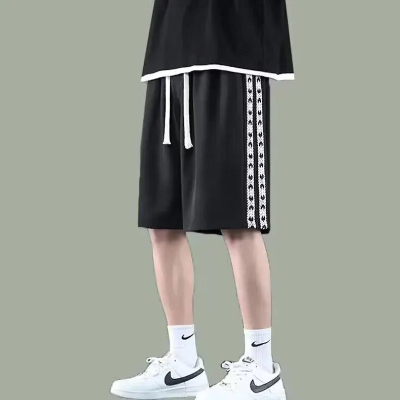 Men's black baggy track pants with loose fit and elasticated waist for casual sports wear