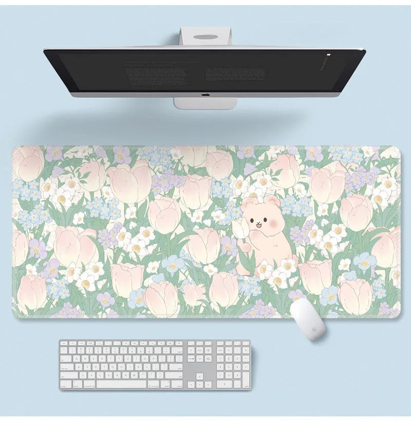 Large floral pattern mouse pad on a desk with keyboard and mouse, showing non-slip rubber base.