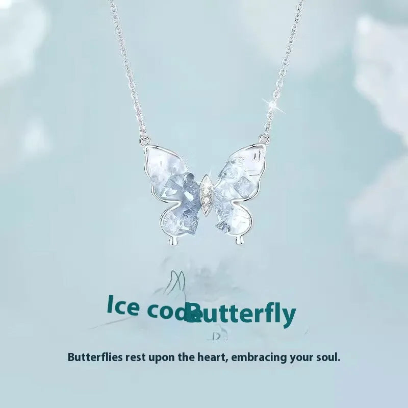 Close-up of a silver butterfly pendant necklace on an adjustable O-ring chain, showing detailed ice rain design.
