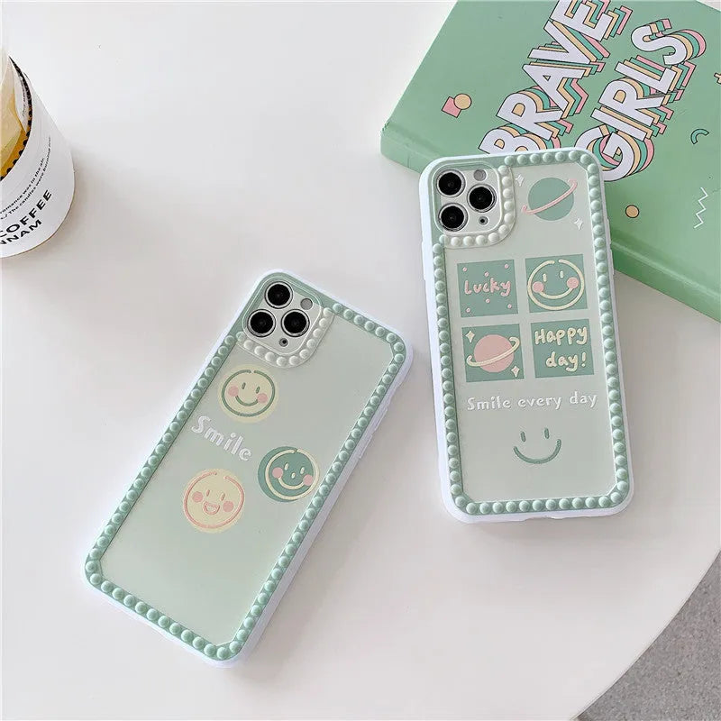 Green iPhone case with smiley face and white polka dot geometric design on the back.
