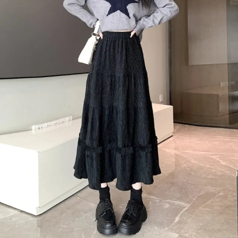 Women's corduroy A-line midi skirt with elastic waistband in milky white, black, and brown colours