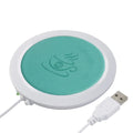 USB heating coaster in black, blue, and orange colours showing USB cable connection