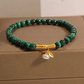 A women's adjustable bracelet made of white crystal with a lucky bamboo charm on the wrist.