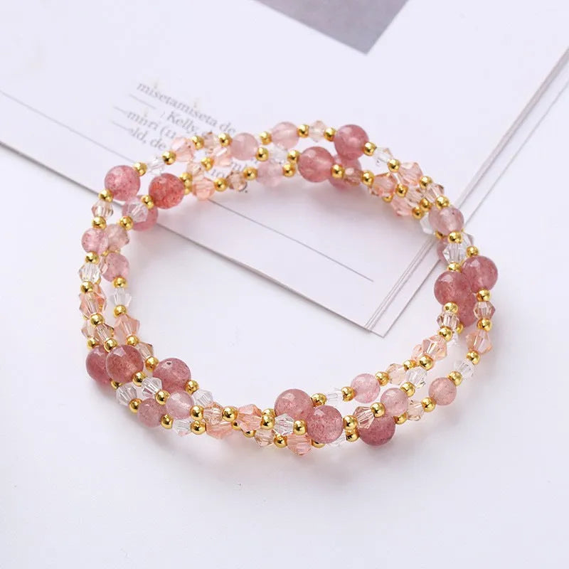 Colourful handmade crystal bracelet with tourmaline, strawberry quartz, and amethyst beads on an adjustable cord.