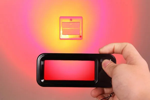 Small red laser reverse camera detector for finding hidden lenses, showing compact dimensions.