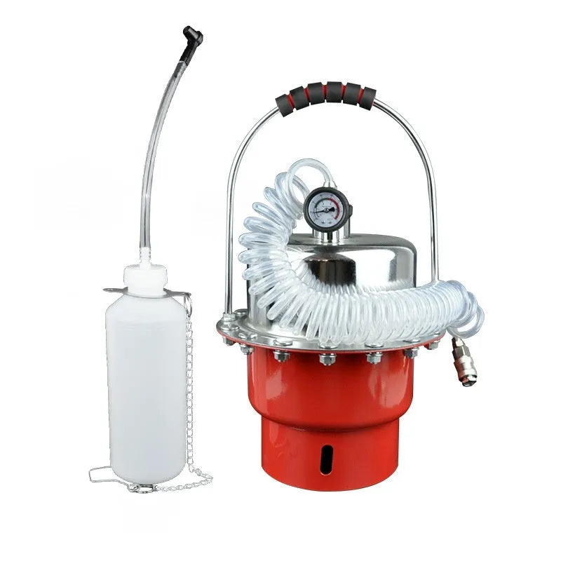 Pneumatic brake fluid replacement machine with large tank, pressure gauge, and regulator on a workshop bench.