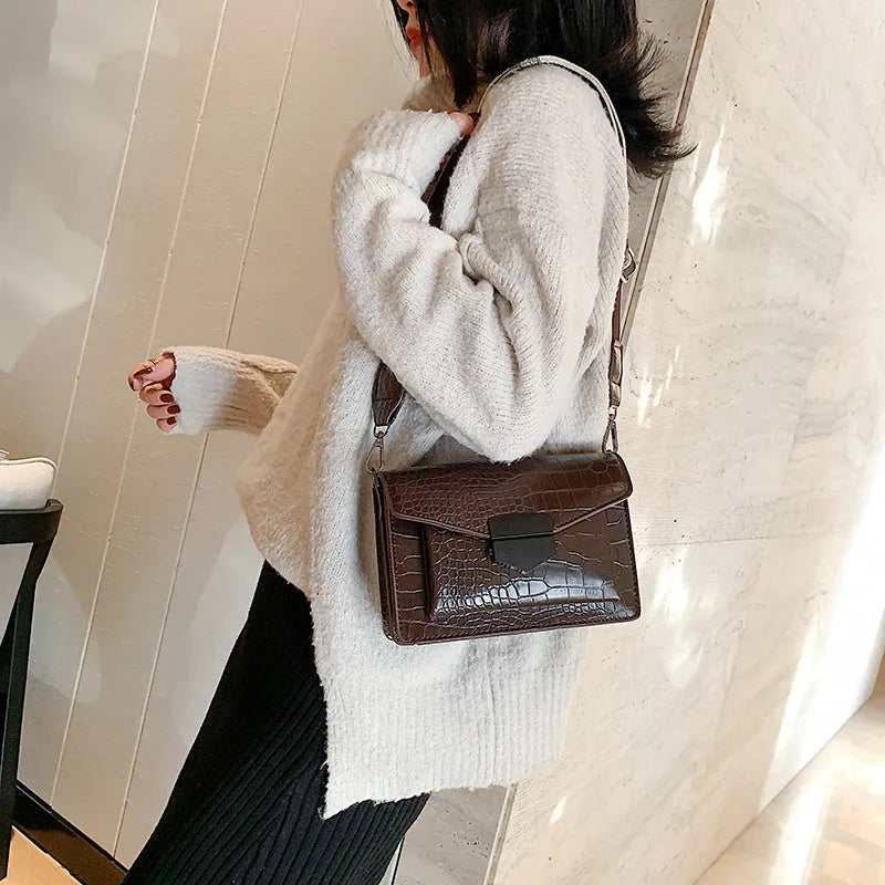 Vintage-style black PU leather crossbody bag with adjustable strap