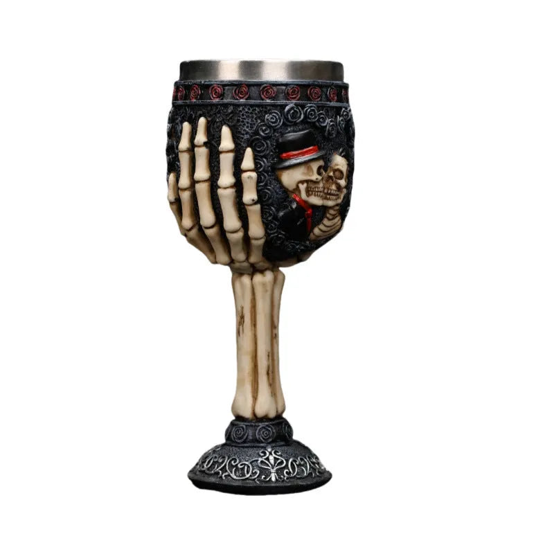 A pair of stainless steel wine glasses with a detailed red human skeleton pattern on a black background.
