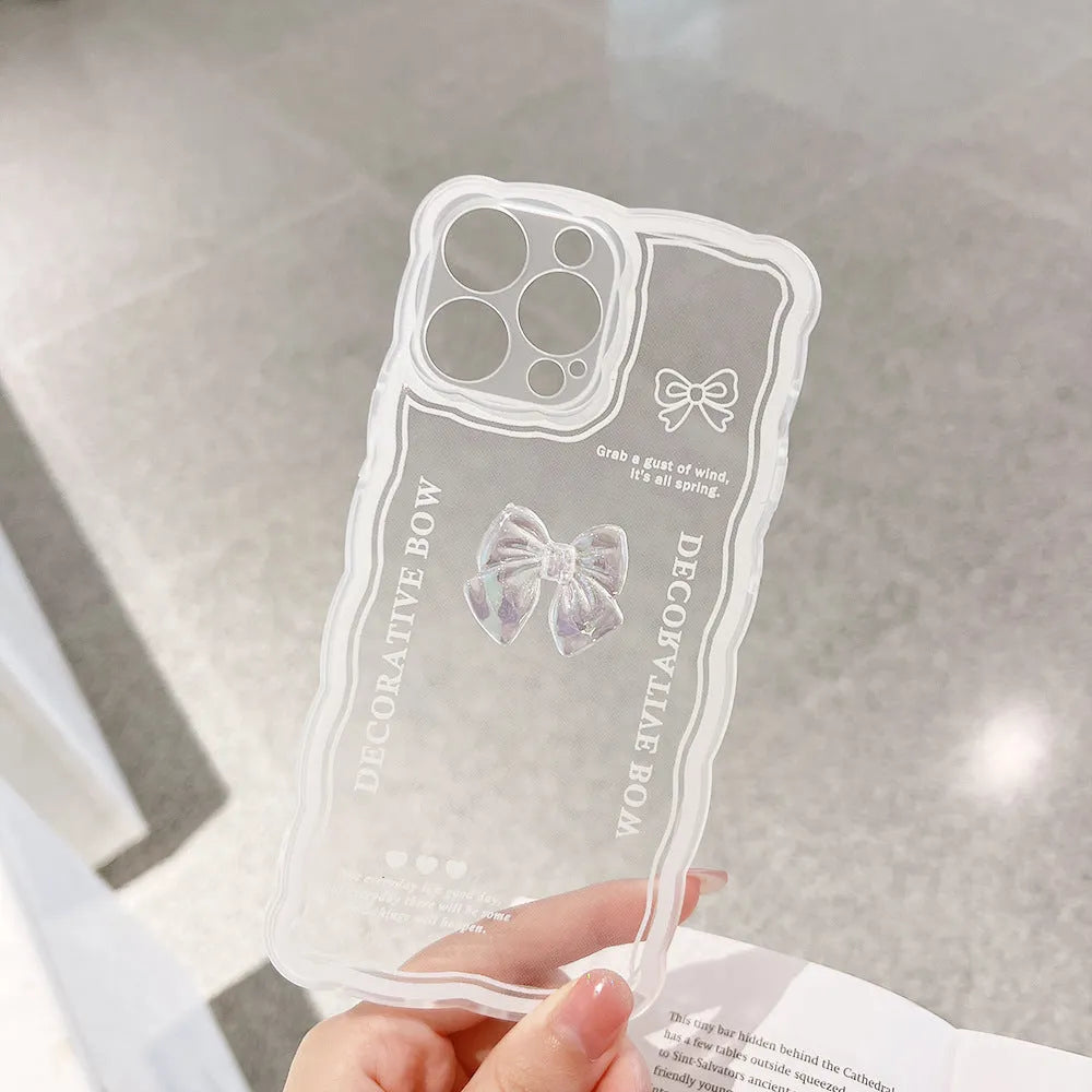 Transparent iPhone case with a raised 3D bow decoration and a white fabric lanyard attached.