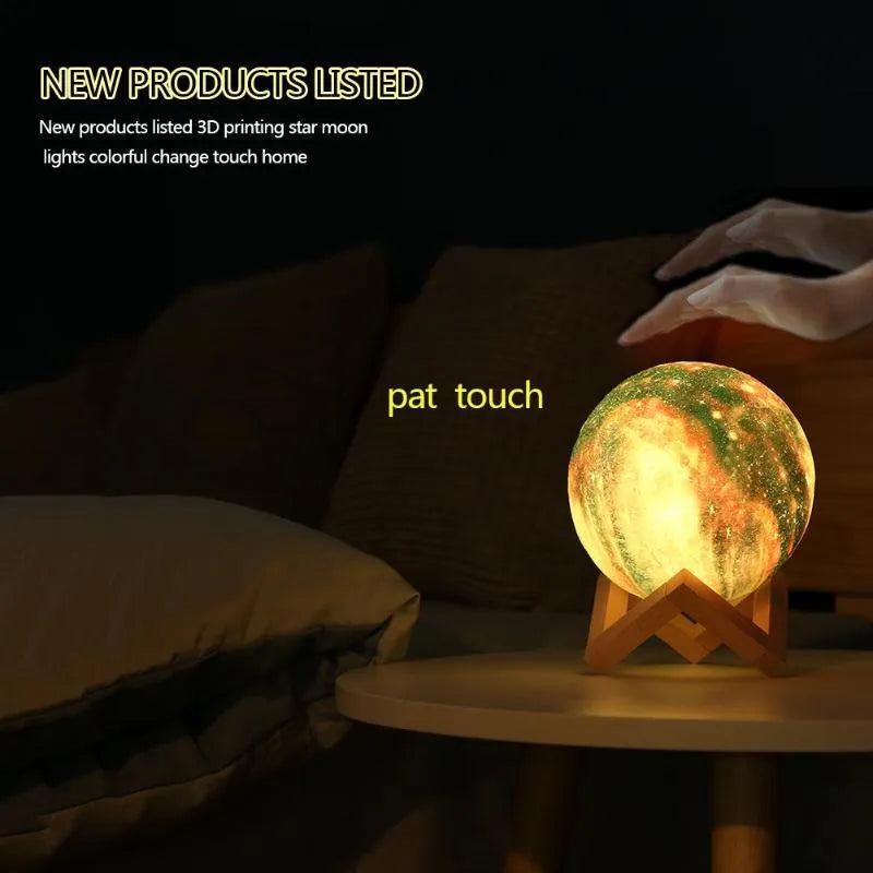 3D-printed spherical lunar night light with colour-changing LED illumination on a dark surface.