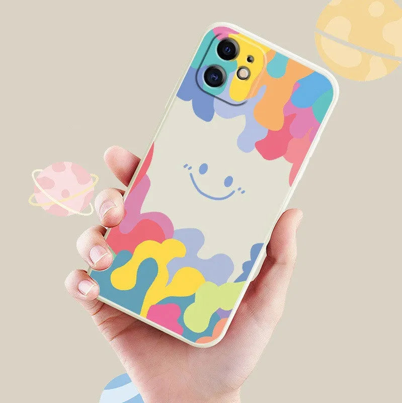 White silicone iPhone case with rainbow smiley face design and attached lanyard