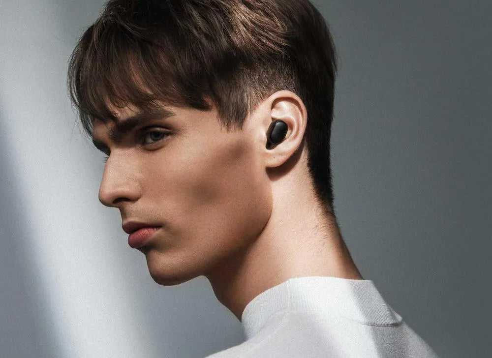 Redmi AirDots Black true wireless earbuds and charging case on a white background.