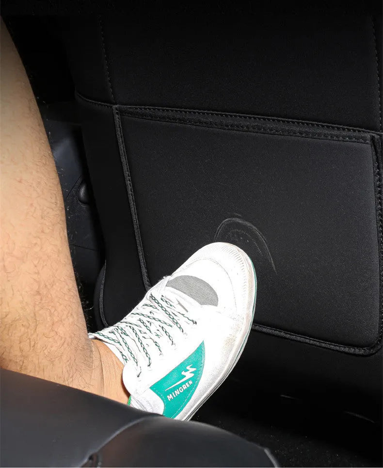 Black leather anti-kick pad for car rear seat protection with centre pocket.