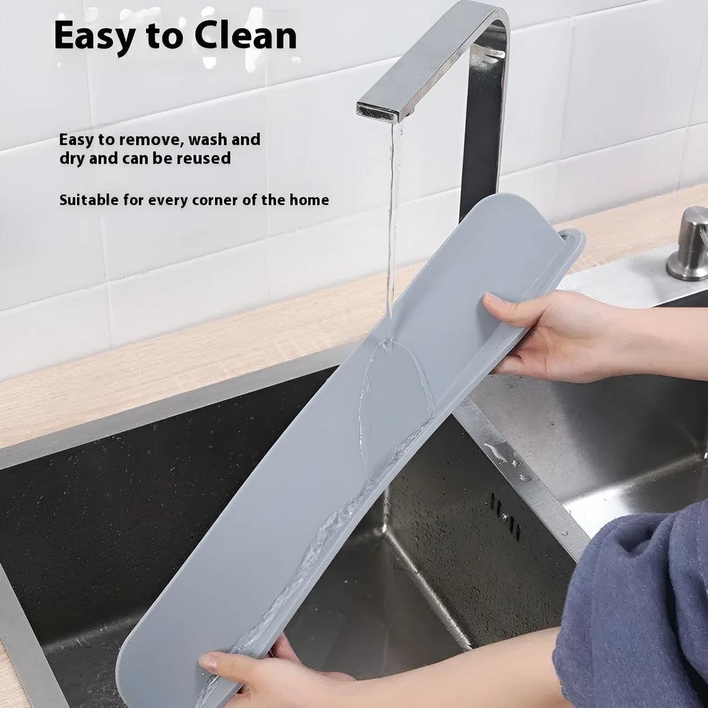 A thick grey silicone kitchen sink water blocking plate or splash guard measuring 52mm by 85mm.