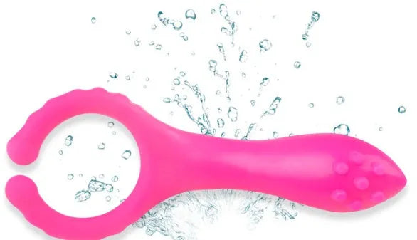 Seismic Clip silicone vibrating clitoral stimulator in rose red, 103mm long, lying flat on a clean surface
