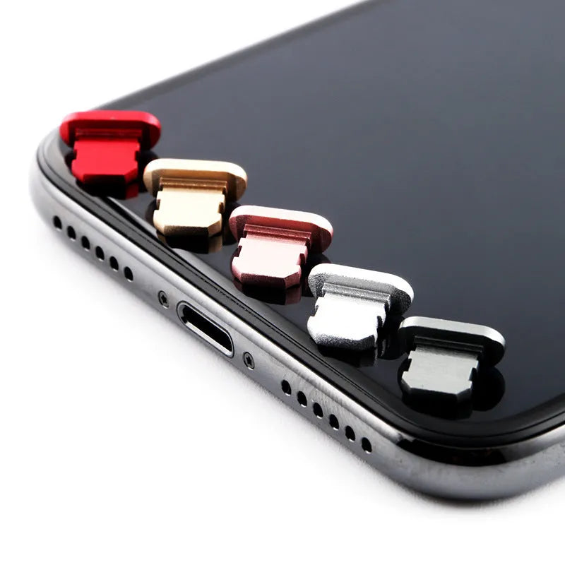 Aluminium alloy dust plug for iPhone charging port in various colours including gold, silver, blue, and rose gold.