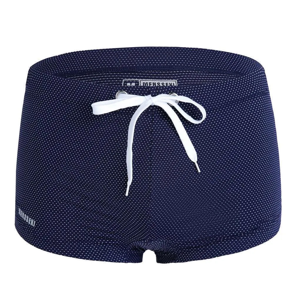 Men's low waist nylon swimming trunks in a solid colour on a white background.