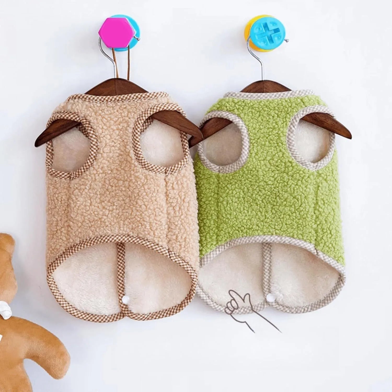 Green coral fleece dog vest with a metal leash ring on the back, shown on a small dog.